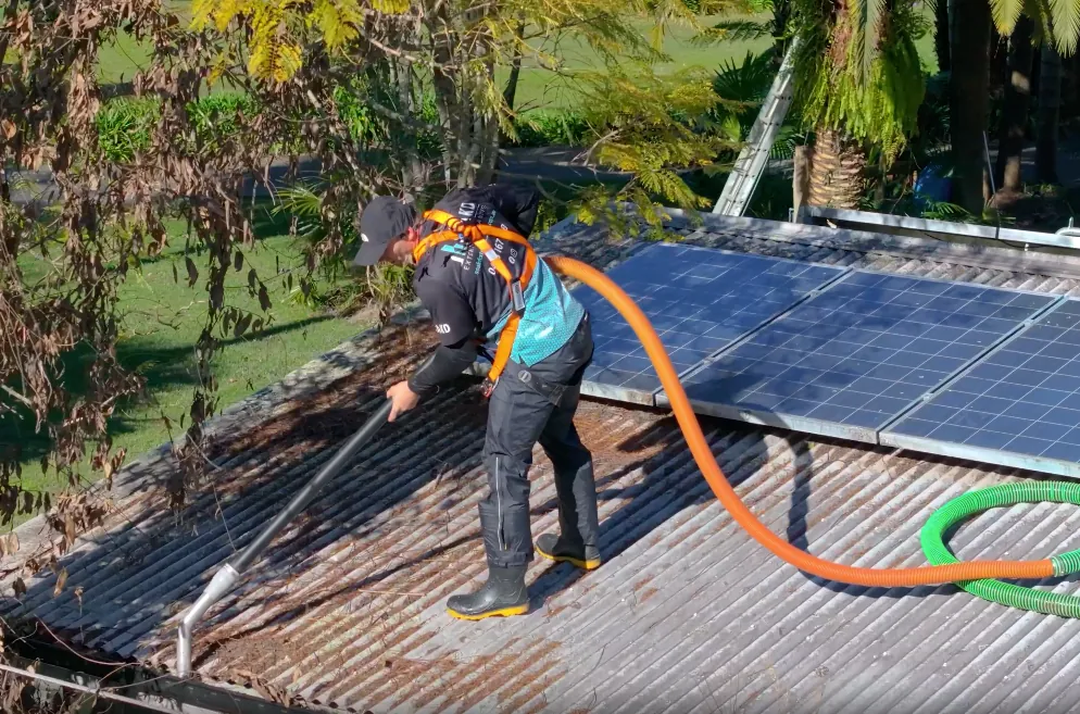 SOAKD operator in full height-safety harness on a residential roof