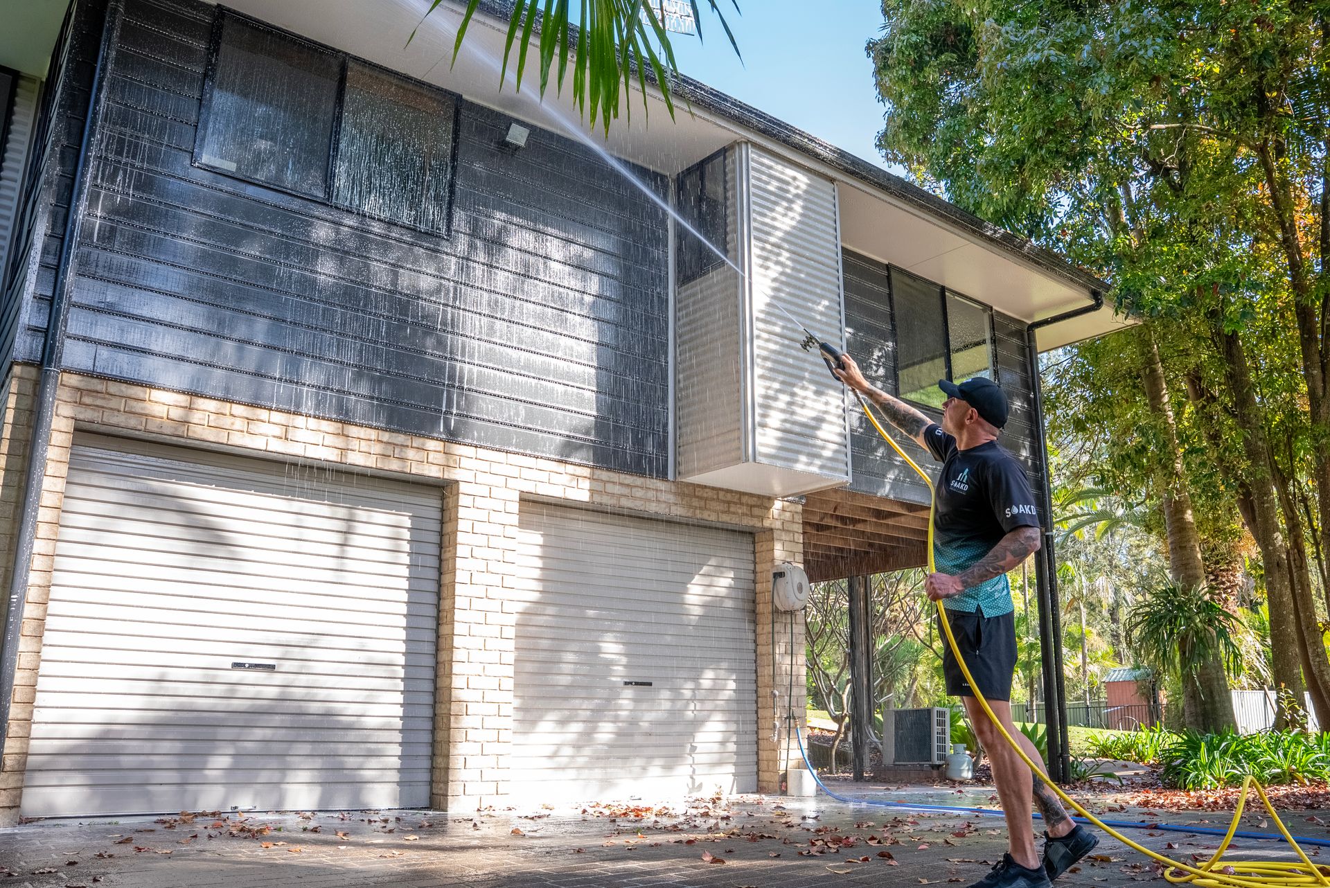 SOAKD technician pressure cleaning an exterior wall